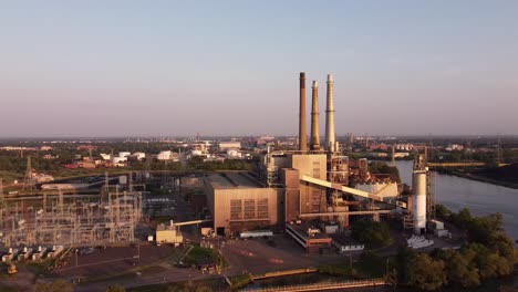 DTE-River-Rouge-Power-Plant-At-Belanger-Park-In-Detroit,-Michigan-On-A-Sunrise---drone-pullback