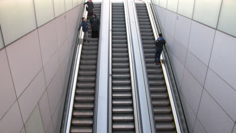 Passengers-On-The-Escalator-At-Amsterdam-Centraal-Railway-Station-In-Amsterdam,-Netherlands---high-angle,-static-shot