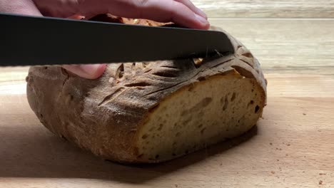 Slicing-sourdough-homemade-bread-loaf-closeup