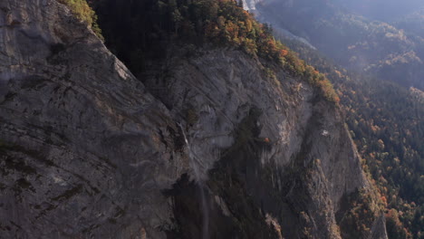 Aerial-of-small-waterfall-on-mountain-ridge