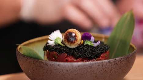 Garnishing-a-delicious-bowl-of-caviar-and-tuna---close-up