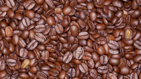 Top-view-of-rotating-roasted-coffee-bean-grains