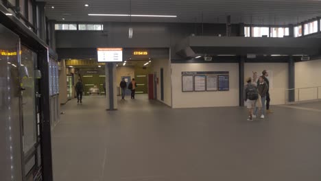 Few-People-Walking-Inside-The-Redfern-Train-Station---Coronavirus-Pandemic---Sydney,-NSW,-Australia