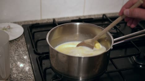 Stirring-ingredients-for-pudding-making-on-gas-hob