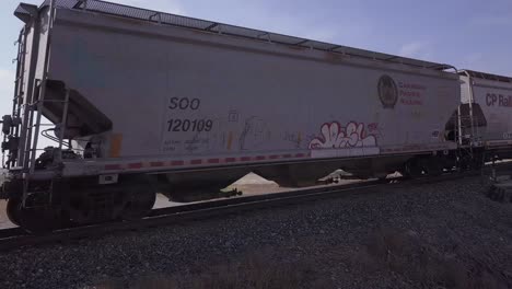 Artsy-pan-on-passing-CP-Rail-train,-ending-with-whip-pan-on-last-car