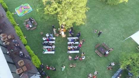 Top-Down-Aerial-View-of-Luxury-Outdoor-Wedding-Ceremony-and-Guests-Clapping-to-Newlywed-Couple