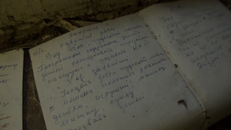 Handwritten-Notes-Scattered-On-The-Ground---Chernobyl-Disaster-In-Pripyat,-Ukraine---handheld-shot