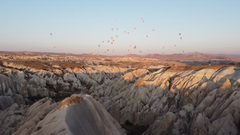Mountains-and-balloons-at-the-magical-sunrise-in-Cappadocia,-Turkey