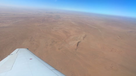 Wide-shot-of-desert-landscape-shot-from-an-aeroplane-in-flight