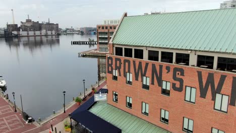 Historic-Brown's-Wharf-at-Fells-Point-and-Patapsco-River,-Chesapeake-Bay-Inner-Harbor,-aerial-dolly-shot