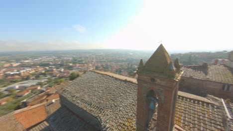 Aerial-View-Of-The-Comune-Of-Sinalunga-In-Siena,-Italy-With-Ancient-Churches-On-A-Sunny-Day---drone-shot,-fpv