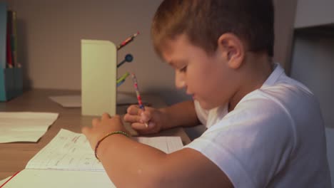 Footage-of-caucasian-six-years-old-boy,-doing-his-homework-lessons-at-home-4K