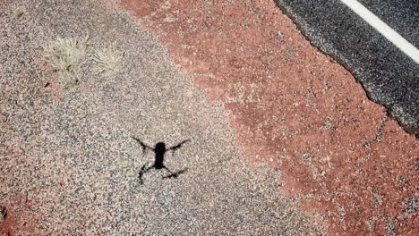 SLOW-MOTION-60FPS,-the-shadow-of-a-landing-drone-being-plucked-from-the-air