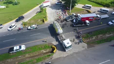 Aerial-view-of-a-oil-truck,-leaving-a-traffic-accident-site---circling,-drone-shot