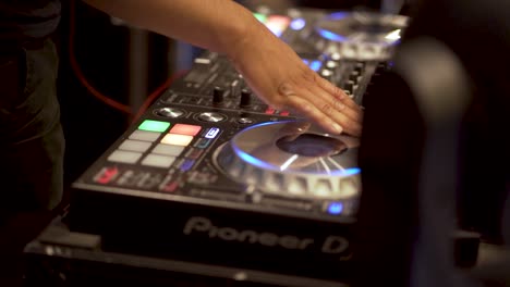 Shot-of-DJ-turning-mixing-deck-wheel
