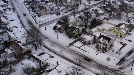 an-aerial-view-over-a-suburban-neighborhood-in-the-morning,-after-a-snow-storm