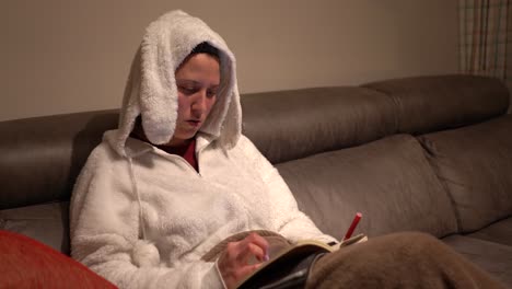 woman-dressed-in-rabbit-pajamas-doing-calculations