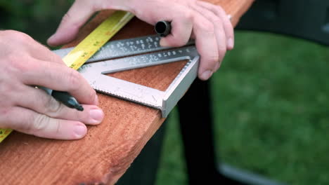 Carpenter-Prepares-Wood-for-Woodworking-Project,-Slow-Motion-Hands-Taking-Measurements-on-Wood-Plank