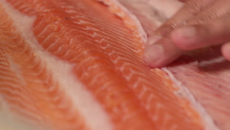 A-Chef-Trimming-The-Meat-Of-A-Fresh-Salmon-Fillet-Using-A-Sharp-Knife-For-Sushi