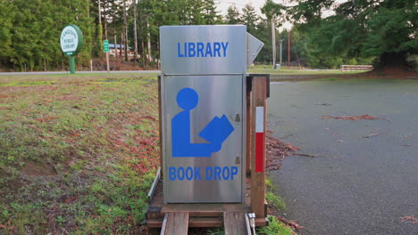 Stainless-Steel-Book-Drop-Off-Box-On-The-Roadside-For-A-Library-In-Langlois,-Oregon---tilt-up