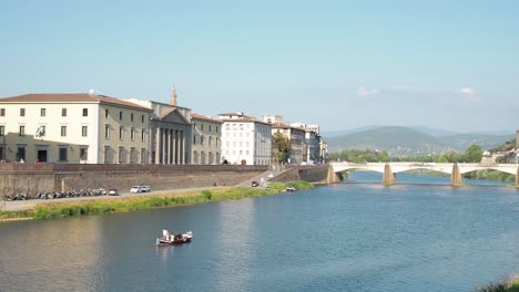 4k-Beautiful-view-of-gondola-floating-down-Arno-river-near-Ponte-Vecchio-bridge