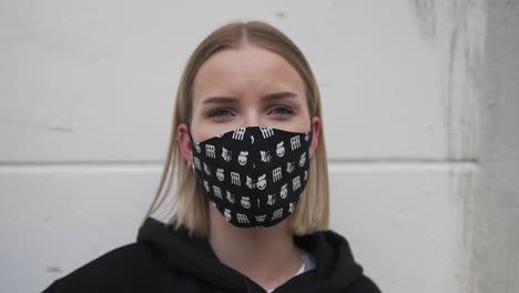 Portrait-of-Young-Woman-With-Face-Mask-Looking-at-Camera,-Close-Up-Slow-Motion