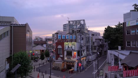 Typical-scenery-in-calm-residential-Tokyo,-Japan-neighborhood-at-dusk-with-illuminated-shops---wide-open-locked-off-view