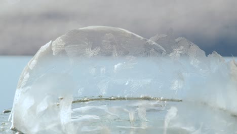 Frozen-broken-soap-bubble-in-cold-light-wind