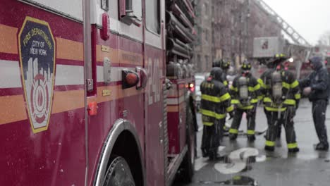 FDNY-Crest-on-Fire-truck-standing-by-under-snowfall-in-Brooklyn-street-ConEd-fire-in-New-York-City---Medium-detail-focus-shot
