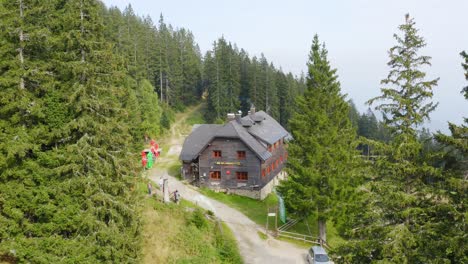 Aerial-push-in-shot-of-a-big-wooden-home-In-the-middle-of-forest