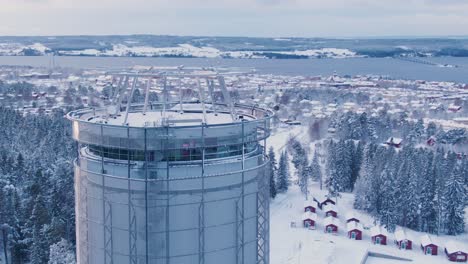 Rapid-arc-aerial-of-tower-in-Östersund-showing-skyline-during-winter