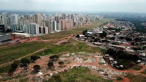 At-a-park-in-a-suburb-near-downtown-Brasilia,-Brazil-trash-litters-the-landscape---aerial-view