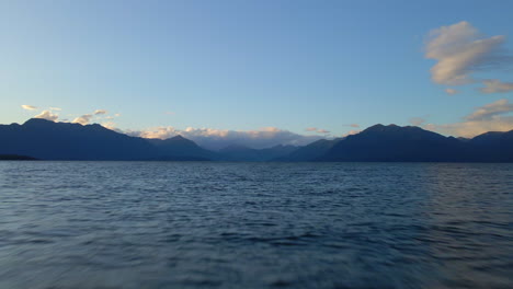 Flying-over-vast-blue-Lake-Te-Anau-with-mountains-in-the-background