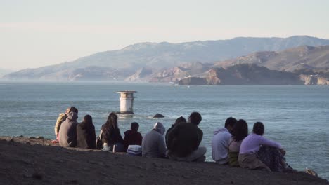 Tourist-Family-Relax-on-the-Edge-of-the-Pacific-Coast-During-Sunset-in-San-Francisco's-Land's-End-Park