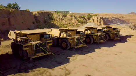 Drone-shot-of-large-dump-trucks-at-a-rock-quarry