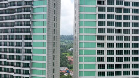 Maj-Meliá-Bandung-Dago-Spa-and-Hotel-mirrored-towers,-Aerial-dolly-out-in-between-shot