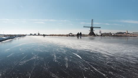 Time-lapse-of-ice-skaters-on-frozen-Dutch-canal,-Netherlands-winter
