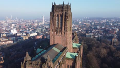 Liverpool-Anglican-cathedral-historical-famous-landmark-aerial-rising-slow-to-city-skyline