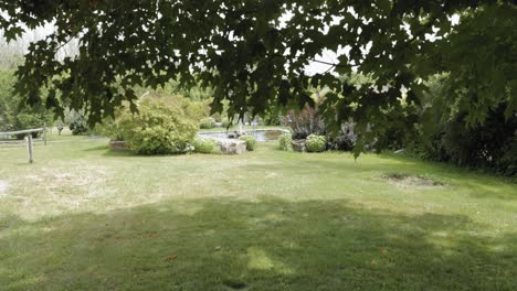 Walking-out-from-below-a-tree-to-reveal-a-beautiful-acreage-yard-with-a-elegant-water-fountain-feature-at-the-Strathmere-Wedding-Centre-and-Spa