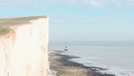 Drone-shot-along-huge-white-chalk-cliffs-South-England-coats-towards-beachy-head-lighthouse