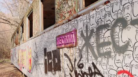 Graffiti-on-abandoned-rusting-train-car-close-up,-Yerevan,-Armenia