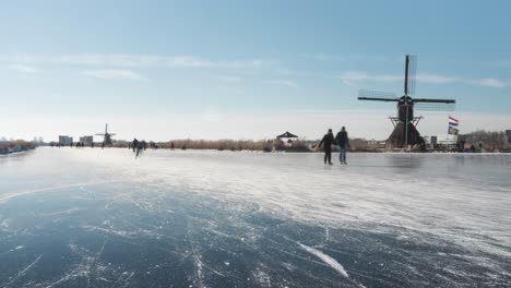 Time-lapse-of-ice-skaters-on-frozen-canal-in-Netherlands-winter