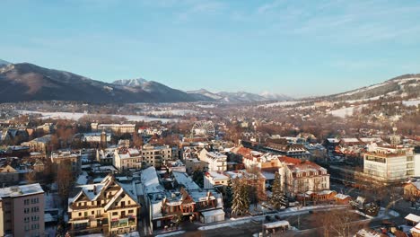 Scenic-View-Of-The-City-And-Mountains-In-Tygodnik-Podhalanski-In-Poland-Europe---aerial-shot