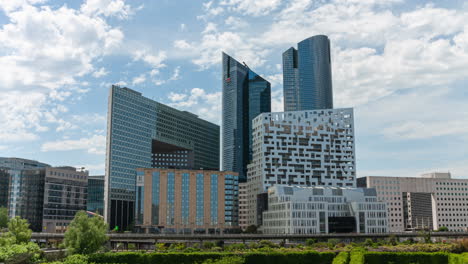 Timelapse-of-office-modern-buildings-in-la-Défense-Nanterre-near-Paris-during-sunny-day-with-clouds