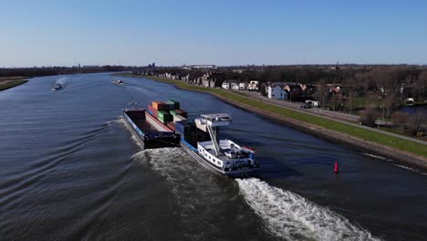 Barge-With-Cargo-Leaving-Wake-On-Noord-River-Near-Hendrik-Ido-Ambacht-In-South-Holland,-Netherlands