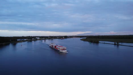 Commercial-Container-Ship-On-River-Water-Of-Oude-Maas-Against-Cloudy-Sky-Near-Barendrecht,-Netherlands