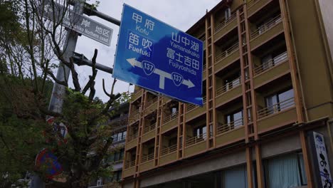 Fuji-Five-Lakes,-Kawaguchiko-Establishing-Shot-of-Hotels-and-Road-Sign