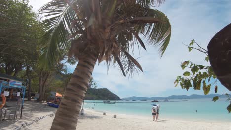 Tourists-taking-photos-on-the-tropical-beach-of-Coral-Island-,-Thailand