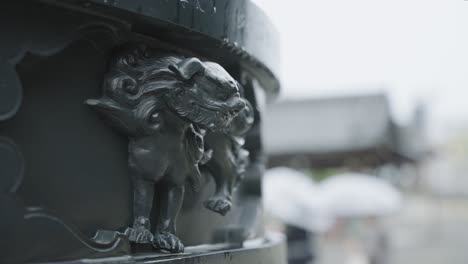 Close-up-of-Lion-Engraving-on-Higashi-Hongan-ji-Temple,-Kyoto-Japan