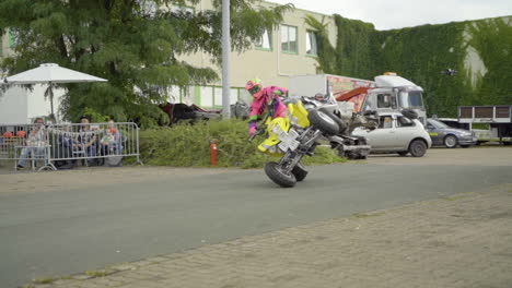 Stunt-Driver-Performing-Side-Wheelie-Driving-On-A-Yellow-Quad-Bike